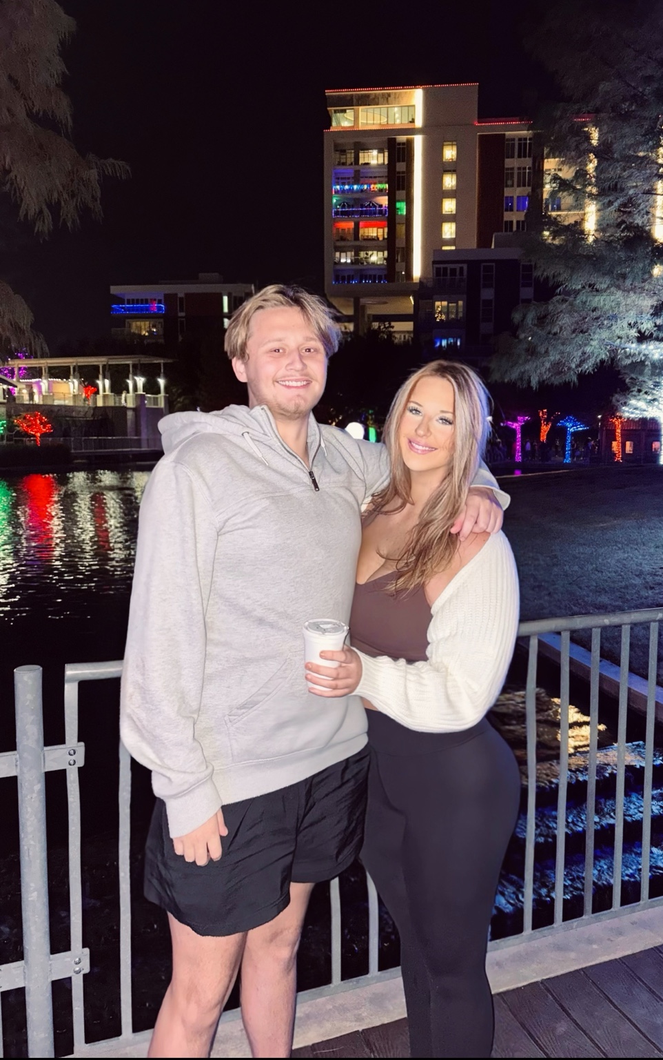 Logan Shipley and his fiancée, Eden, together beside the water at night
